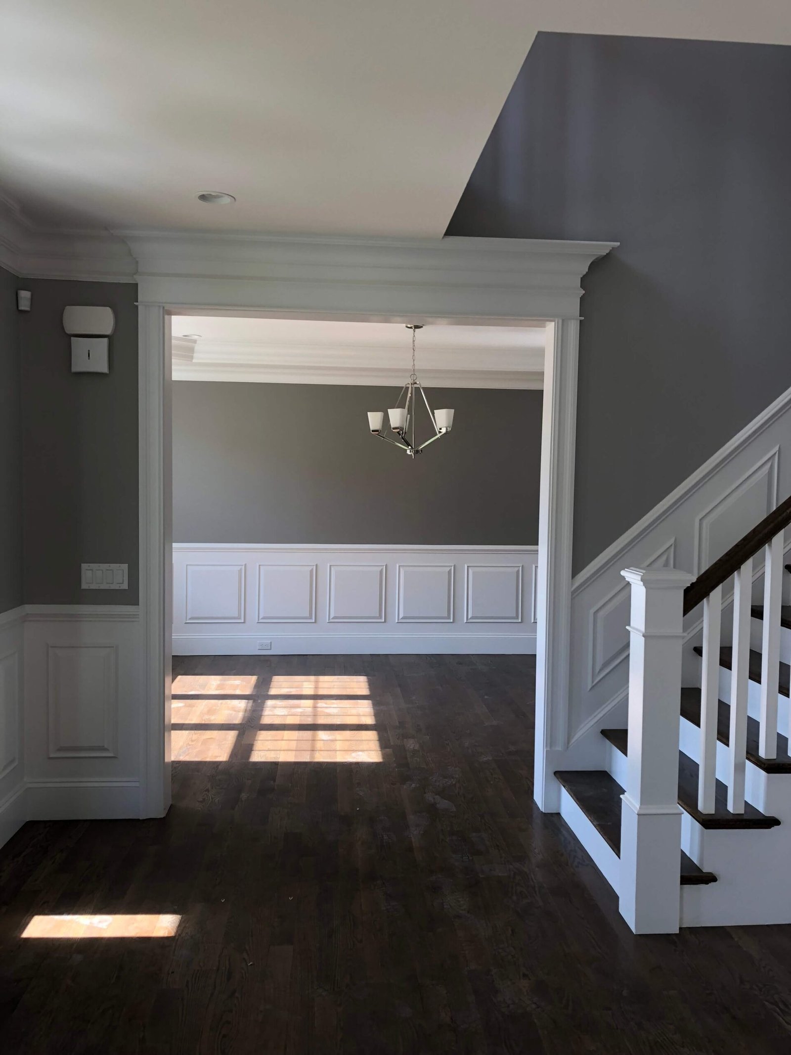 Entryway with staircase vista and wainscoting